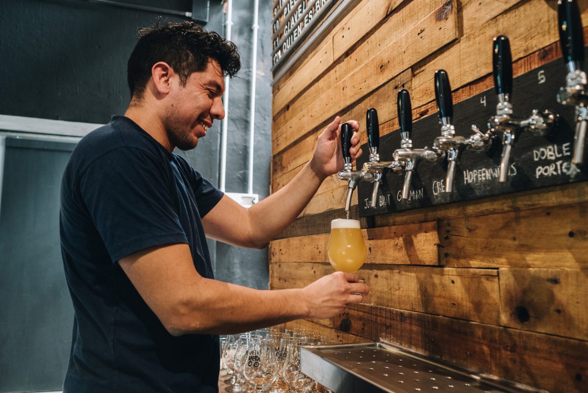 Bartender pouring beer while smiling