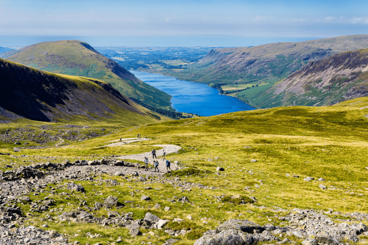 Walkers on Scafell Pike with Wastwater in the background