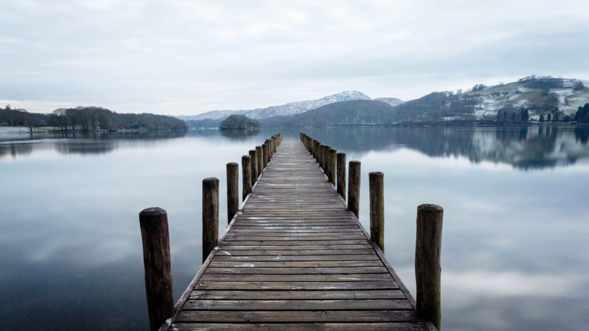 View of fells around Coniston in winter rom a jetty at Coniston water 