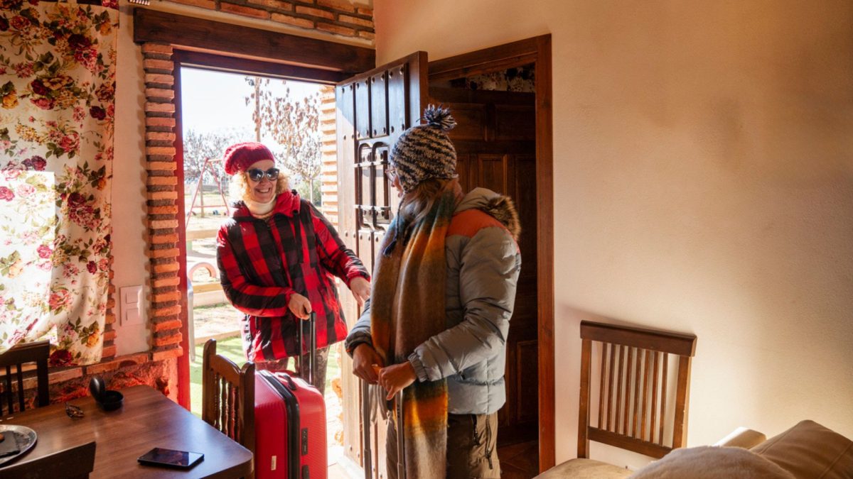 two friends arriving at a cottage together