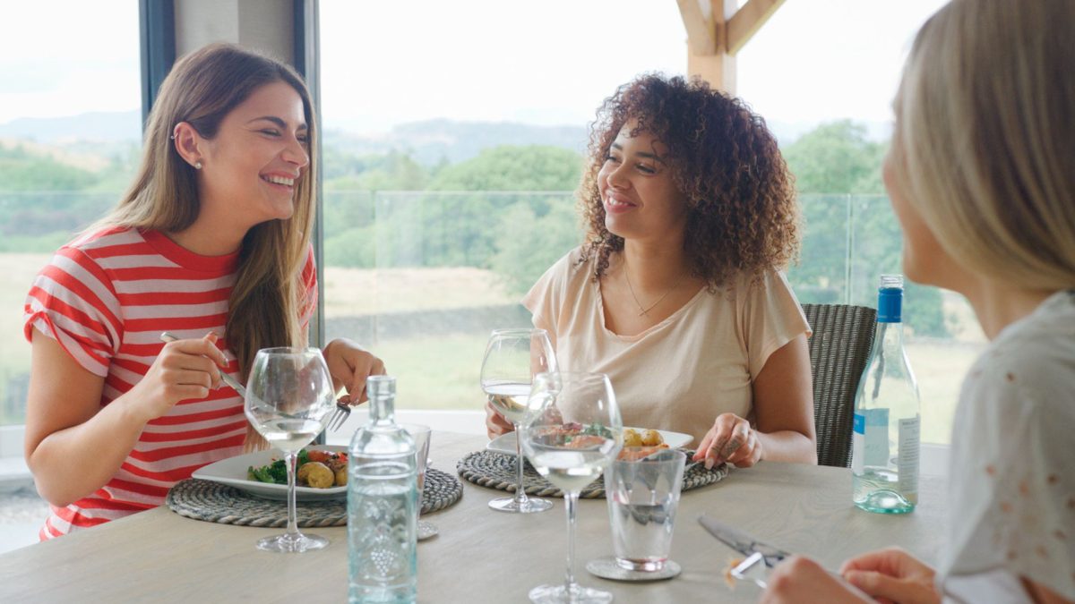 friends smiling and eating a meal